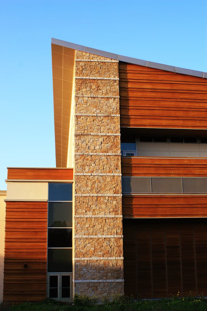 Photo: Robert Lowell Mast (CC BY 2.0) Stone pillar and warm wood-clad walls of the Green Music Center against a clear blue sky at Sonoma State University