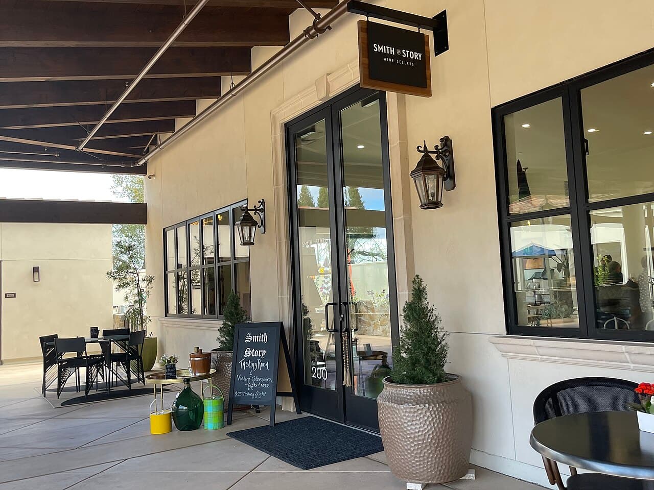 Covered patio with bistro tables outside the Smith Story Wine Cellars tasting room