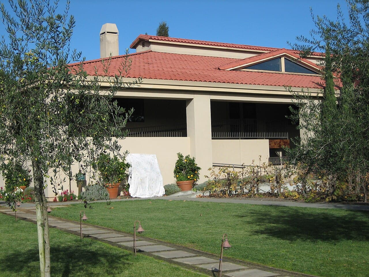 Lawn and stepping-stone path beside the tile-roofed Seghesio winery building