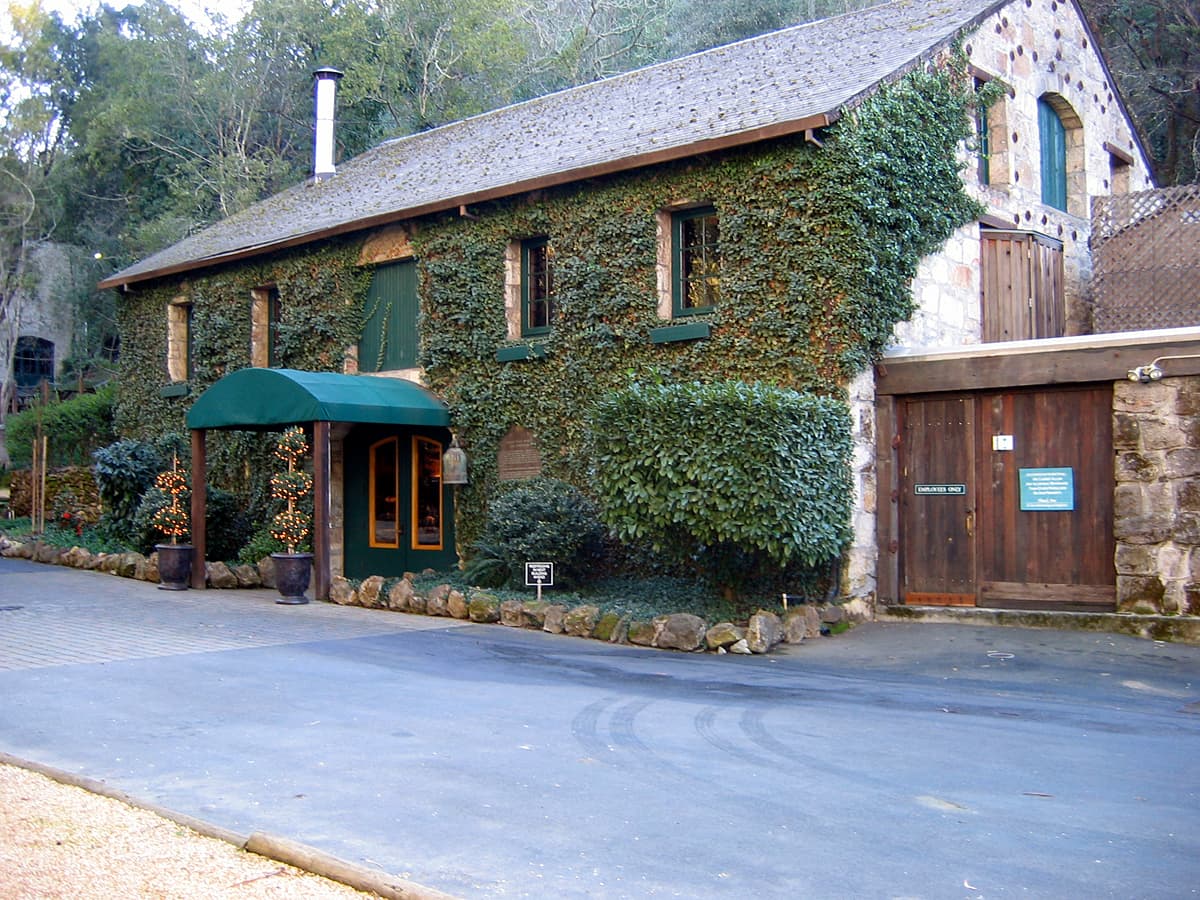 Ivy-covered stone winery building with a green entrance awning at Buena Vista Winery