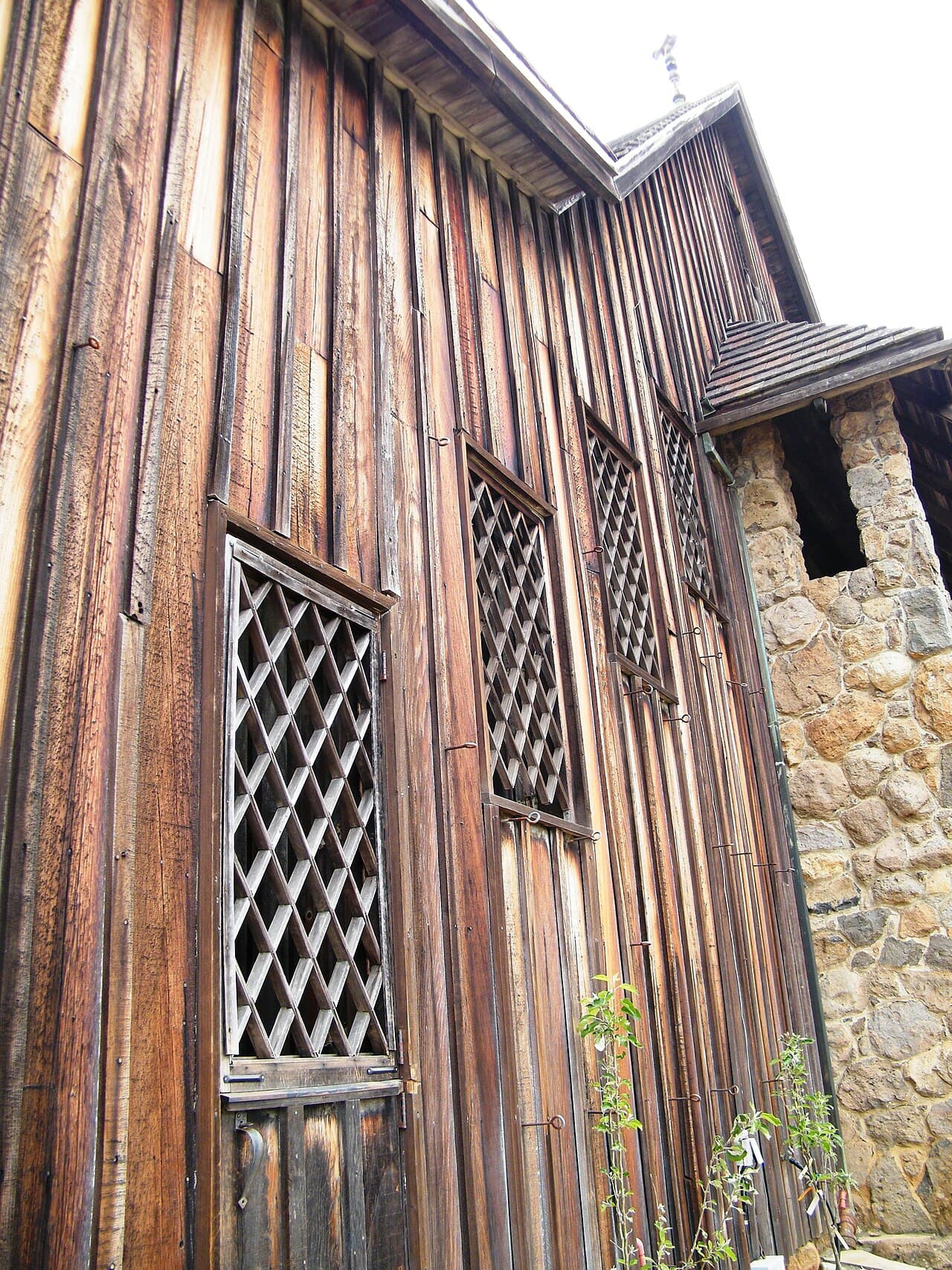 Weathered board-and-batten and stone Hanzell Vineyards building that holds the tasting room and cellar