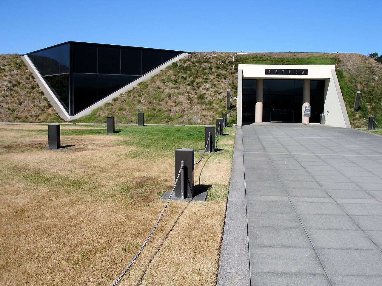 Artesa's grass-roofed winery built into the Carneros hillside, with a stone walkway to the entrance