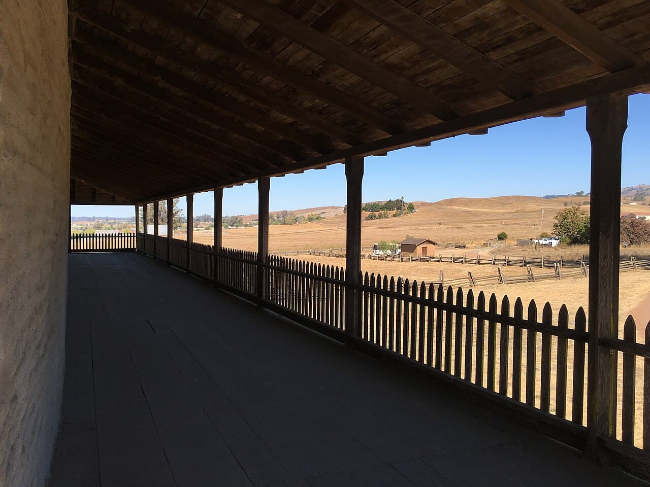 View from the Petaluma Adobe's long wooden veranda out over the golden Petaluma Valley hills