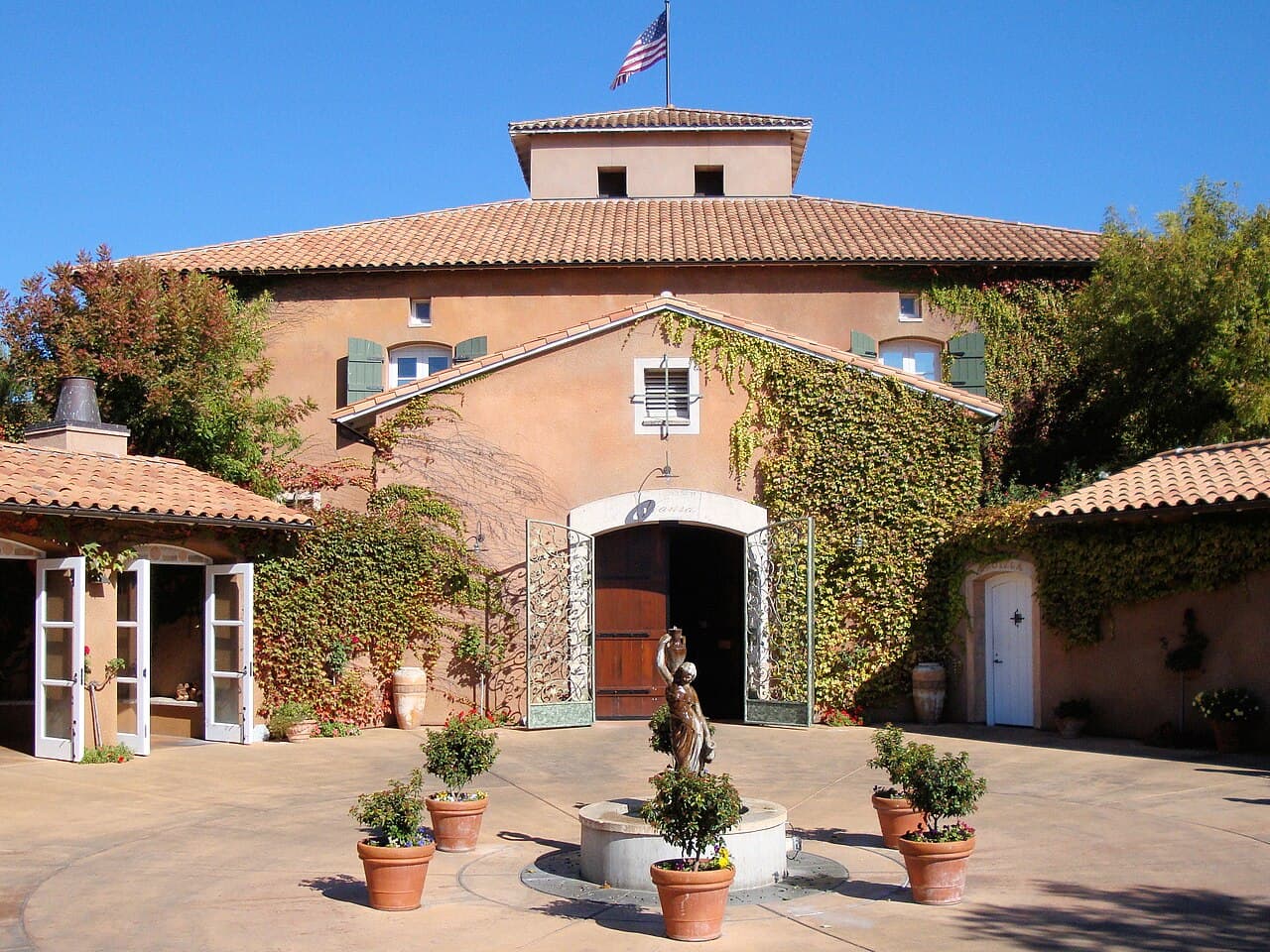Tuscan-style villa courtyard with fountain, potted trees and ivy-covered walls at Viansa Winery