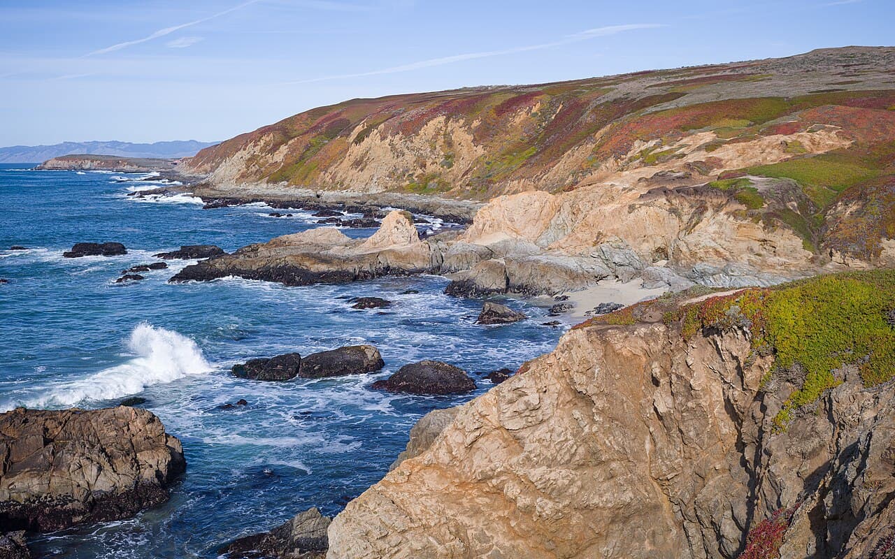 Rocky cliffs, sea stacks and surf along the coastline seen from Bodega Head in Sonoma Coast State Park
