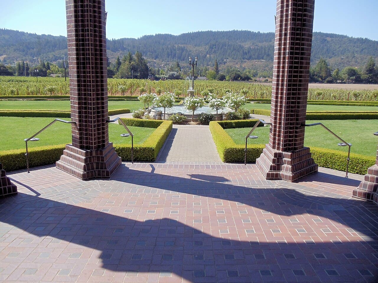 Brick portico framing the formal fountain garden, lawns and vineyards at Ledson Winery