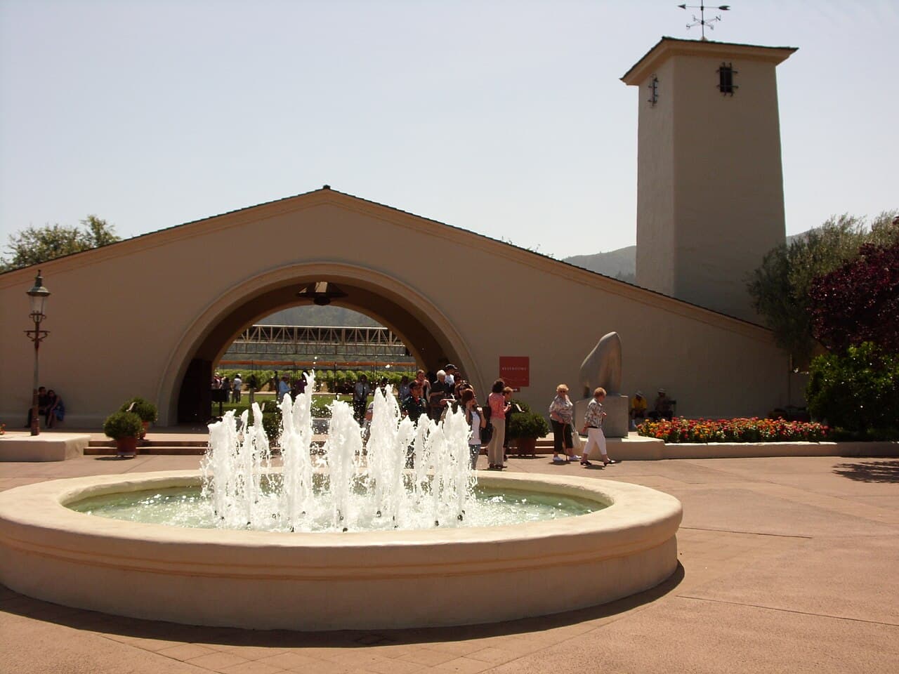 Fountain in front of the wide arched entry and bell tower of the mission-style Robert Mondavi Winery